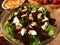 Homemade Beetroot Salad with Goat Cheese, Arugula and Sesame Seeds in Glass Bowl.