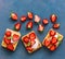 Homemade Belgian waffles with cream and fresh strawberries on a blue woody background. Top view, flat lay, space for text