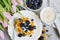 Homemade Belgian Waffles with Cream Sauce Berries, Cup with Cappuccino Beverage Flowers Pink Tulips, Gray Background Table Kitchen