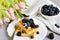 Homemade Belgian Waffles with Cream Sauce Berries, Cup with Cappuccino Beverage Flowers Pink Tulips, Gray Background Table Kitchen