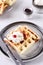 Homemade Belgian Waffles served with whipped cream Chantilly and berry jam