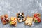 Homemade Belgian waffles with a variety of fruits on a gray background. Top view, copy space.