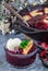 Homemade berry cobbler in glass ramekin with ice cream, Christmas decoration, vertical