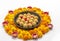 Homemade besan laddoo with flowers kept with rangoli