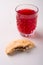 Homemade bitten shortbread chocolate cookie with stewed fruit red compote drink in glass on white wooden table