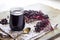 Homemade black elderberry syrup in glass jar