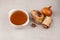 Homemade boiled beef bone broth in white bowl on stone table. Selective focus, copy space. Golden meat bouillon. Bones contain