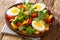 Homemade boiled eggs and salad of lupine beans, tomatoes and feldsalat close-up in a plate. horizontal