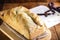 Homemade bread made in the Easter and Eucharist period, called Christ bread, religious symbol, with Bible and crucifix in the