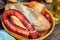 Homemade bread and sausage on a wooden table. Retro food, bottle of olive oil