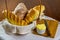 Homemade breads. different types of home-made breads in basket with wooden cutting board, knife and porcelain ramekin with butter