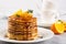 Homemade breakfast or brunch: american style pancakes served with orange and sprinkled syrup