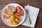 Homemade Breakfast, Scrambled egg with tomato sliced, bacon grill and breads on plate. Top view