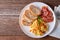 Homemade Breakfast, Scrambled egg with tomato sliced, bacon grill and breads on plate. Top view with Copy space