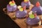 Homemade bright mousse cakes `Hearts` with purple mirror icing