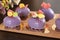 Homemade bright mousse cakes `Hearts` with purple mirror icing