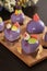 Homemade bright mousse cakes `Hearts` with purple mirror icing