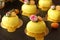 Homemade bright mousse cakes `Hearts` with yellow mirror coating