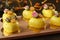 Homemade bright mousse cakes `Hearts` with yellow mirror coating