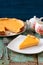 Homemade bright pumpkin pie and teaware on shabby wooden table