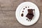 Homemade brownie served with chocolate fudge. Sweet dessert on wooden background