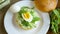 Homemade bun with cheese spread, fresh arugula and boiled egg in a plate