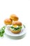 Homemade bun with cheese spread, fresh arugula and boiled egg in a plate