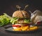 Homemade burger on dark rustic wooden background with French fries , front view, close up. Fast food