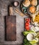 Homemade burger ingredients on kitchen table background with cutting board, top view