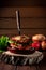 Homemade burger made with hashbrown potatoes, salad, beef patty, cheese, tomatoes, concept of menu for restaurant in rustic style