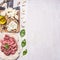 Homemade burgers, ground beef, herbs, oil and onion border ,place for text wooden rustic background top view