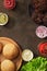 Homemade burgers ingredient on the rusty background.