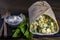 Homemade burrito wraps with boiled eggs, potato, green wild garlic and sour cream for healthy breakfast on plate, closeup