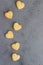 Homemade butter and sugar heart-shaped cookies, grey stone background.