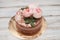 Homemade buttercream round cake with pink rose flowers on top, valentines love concept
