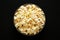 Homemade Buttered Popcorn with Salt in a Bowl on a black background, top view. Flat lay, overhead, from above