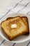 Homemade Buttered Toast on a white plate, low angle view