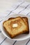 Homemade Buttered Toast on a white plate, low angle view. Copy space