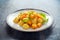 Homemade Butternut squash gnocchi with wild rocket in a plate