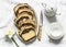 Homemade buttery cake with chocolate nut streusel, tea set on a light background, top view