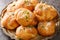 Homemade Buttery Garlic Knot Bread with Parsley and Parmesan cheese and dried greens closeup on the plate. Horizontal