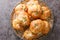 Homemade Buttery Garlic Knot Bread with Parsley and Parmesan cheese and dried greens closeup on the plate. Horizontal top view