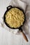 Homemade Cacio E Pepe Pasta with Pecorino Romano and Pepper in a cast-iron pan, top view. Flat lay, overhead, from above