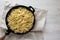 Homemade Cacio E Pepe Pasta with Pecorino Romano and Pepper in a cast-iron pan on a white wooden background, top view. Flat lay,