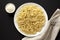 Homemade Cacio E Pepe Pasta with Pecorino Romano and Pepper on a white plate on a black background, top view. Flat lay, overhead,