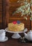 Homemade cake on a ceramic stand for the cake, tea set, paper hearts, a flower. Valentine\'s day romantic Breakfast.