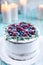 Homemade cake decorated berries on plate over wooden turquoise background