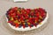 Homemade cake with Strawberries and blueberries for Valentine\'s Day heart shaped on a glas plate tablecloth