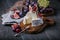 Homemade camembert cheese with fresh fruits on wooden board