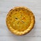Homemade Canadian Tourtiere Meat Pie on a white wooden table, top view. Flat lay, overhead, from above. Close-up